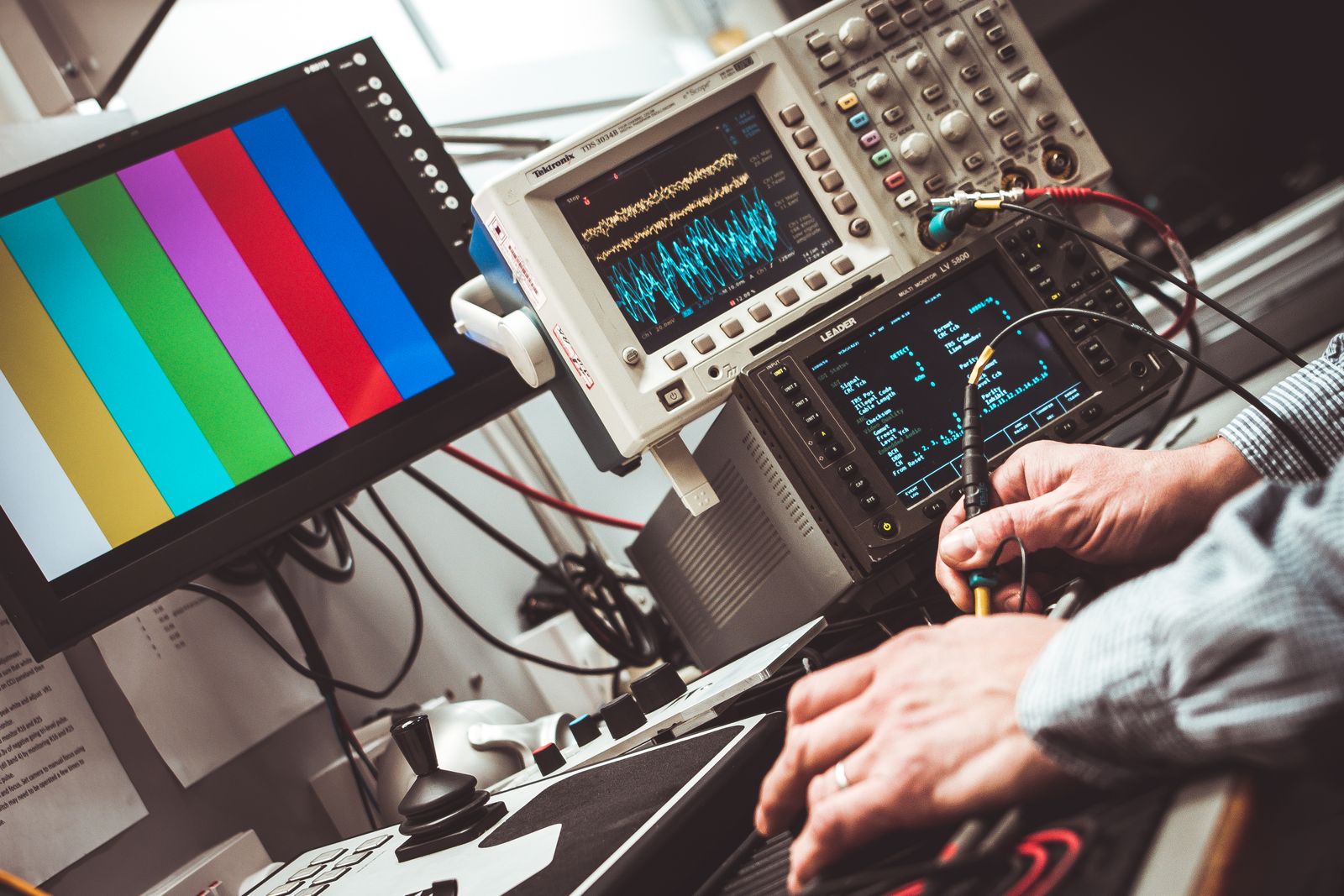 Technician checking signals with an oscilloscope